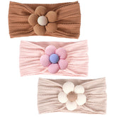 MIUXUESO baby flower headbands beige close-up showing soft elastic fit for newborns