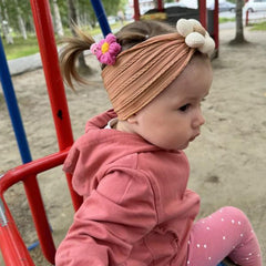 MIUXUESO flower headbands on a baby girl for charming photos and outfits.