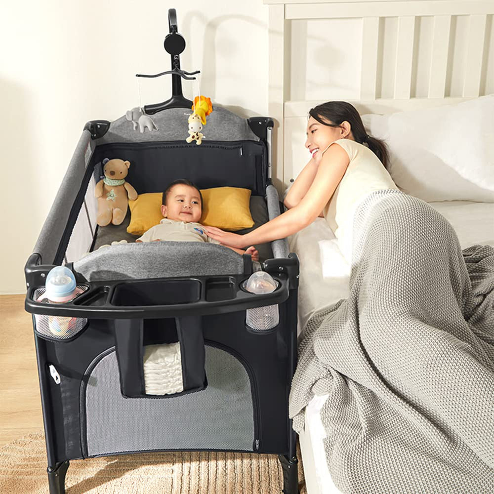 MMBABY 5-in-1 pack and play crib setup showing compact frame for travel-friendly sleep