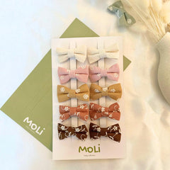 MoLi Baby Collection 10-piece floral bow clips in autumn tones for easy daily styling.
