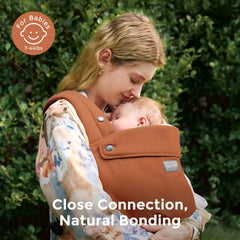 Momcozy baby carrier demonstrates ergonomic M-position for hip-friendly seating.