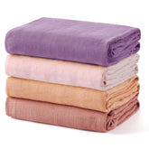 Momcozy swaddle blanket 4-pack laid flat in soft earth tones.