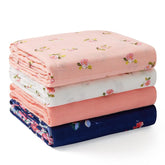 Momcozy muslin swaddle floral pattern closeup showing breathable softness.