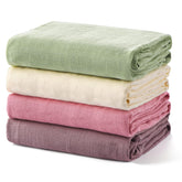 Momcozy Muslin Swaddle Blanket soft closeup for gentle newborn comfort.