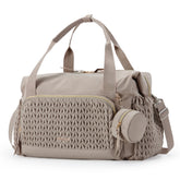 Mommore diaper bag tote shows spacious compartments for organizing baby essentials on the go.