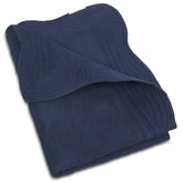 MONOBLANKS baby quilt with scalloped edge adds a delicate nursery accent and cozy texture