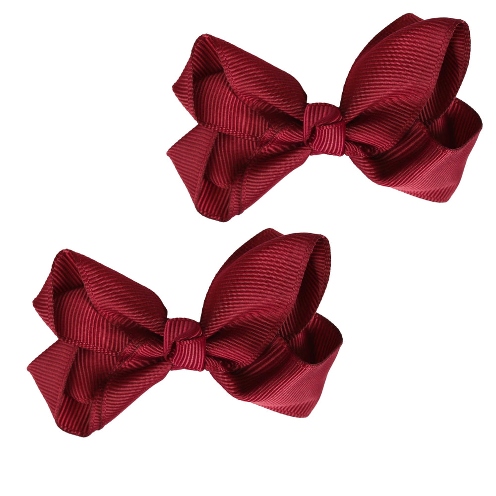 Motique Burgundy bow set on an alligator clip adds cheerful charm to everyday outfits.
