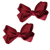 Motique Burgundy bow set on an alligator clip adds cheerful charm to everyday outfits.