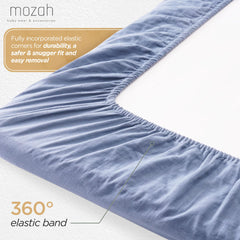 Mozah Organic Muslin Crib Sheets on crib illustrating snug secure fit