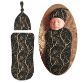 Muishi swaddle blanket with cute raccoons on branches offers gentle snuggle for newborn sleep.