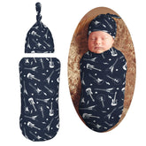 Muishi guitar and stars swaddle blanket close-up shows soft fabric for cozy newborn comfort.