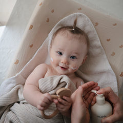 Mushie Baby Lotion on soft baby skin demonstrates moisture and softness.