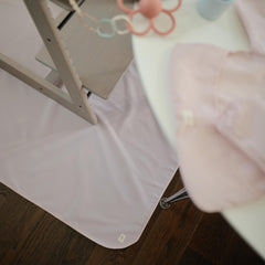 Mushie Baby Splat Mat Fog used for arts and crafts on a protected table