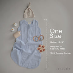 Mushie baby wearable blanket Sage in crib illustrates safe sleep environment.