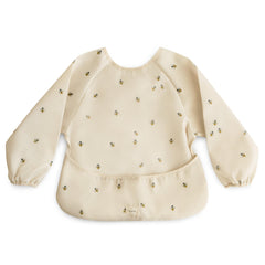 Mushie Bees long sleeve bib front view with water-resistant fabric for quick spill cleanup.
