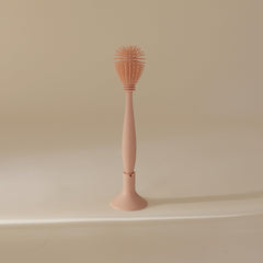 Mushie suction-base design keeps the brush ready for quick storage.