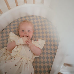 Mushie cotton soft fabric closeup shows skin-friendly material handling saliva.