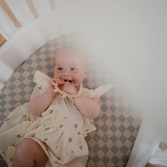 Mushie blue check full-bed fit shows deep pockets for standard crib mattress