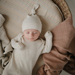 Mushie crib sheet with elastic fit and deep pockets for a snug stay