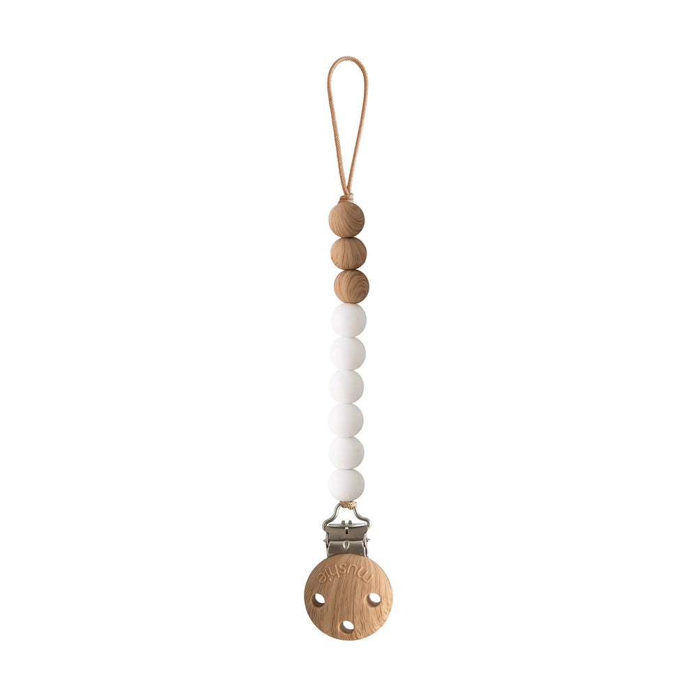 Mushie Eva pacifier clip with white beads keeps pacifier secure on the go