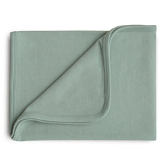 Mushie Extra Soft Baby Blanket in Roman Green ribbed cotton ready for swaddling and cuddling