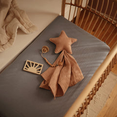 Mushie deep pockets ensure a secure fit on a standard crib mattress.