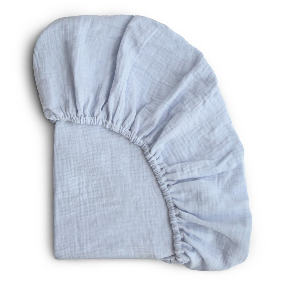 Mushie extra-soft muslin crib sheet baby blue closeup highlighting plush texture for gentle sleep.