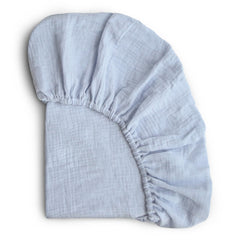 Mushie extra-soft muslin crib sheet baby blue closeup highlighting plush texture for gentle sleep.