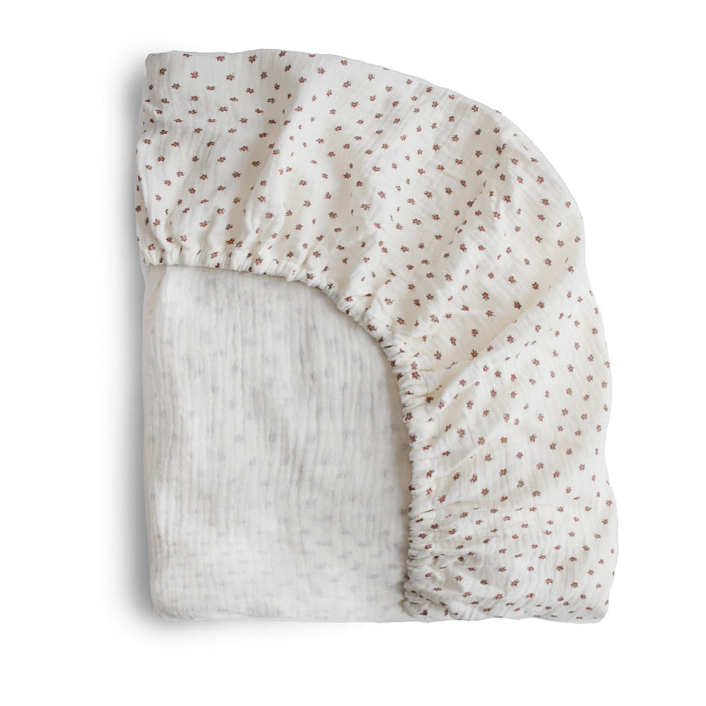 Mushie extra-soft muslin crib sheet bloom close-up showing gentle, skin-friendly cotton