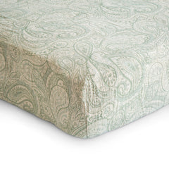 Mushie extra soft muslin fitted crib sheet Green Paisley on mattress highlights breathable, cozy sleep surface.