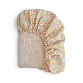 Mushie extra soft muslin fitted crib sheet in pastel blooms offers gentle, breathable comfort.