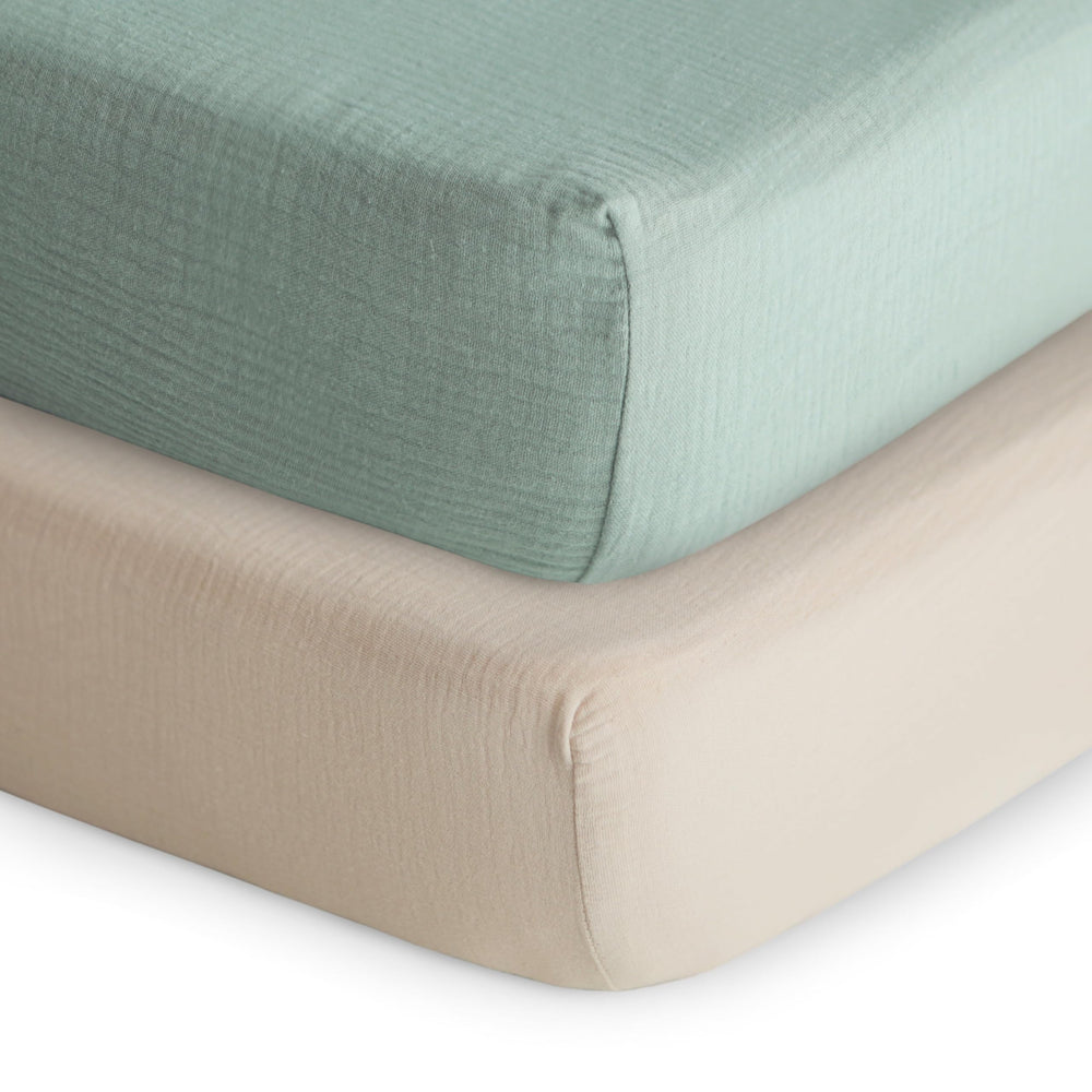 Mushie extra-soft muslin fitted crib sheet in Roman Green for gentle skin comfort.