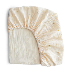Mushie extra-soft muslin fitted crib sheet texture close-up for breathable baby comfort.
