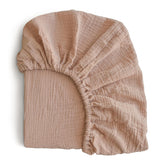 Mushie extra soft muslin fitted crib sheet texture shows breathable cotton for gentle baby comfort.