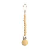 Mushie Hera pacifier clip 8inch closeup, durable silicone for on-the-go use.