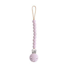 Mushie Hera pacifier clip soft lilac close-up showing secure on-the-go attachment