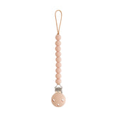 Mushie Hera pacifier clip with soft pink beads for secure on the go use.