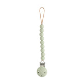 Mushie Hera Sage pacifier clip closeup shows silicone beads and screw-free clasp.