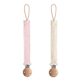 Mushie linen pacifier clip with soft fabric strap keeps pacifier within baby's reach