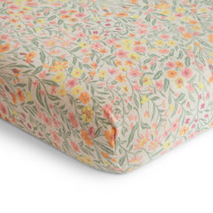 Mushie pastel blooms muslin crib sheet uses breathable fabric for cozy sleep environments.