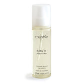 Mushie Organic Baby Oil bottle closeup showing fragrance-free, lightweight formula for delicate newborn skin.