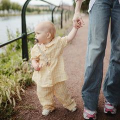 Mushie pacifier clip stroller use demonstrating travel-ready convenience.