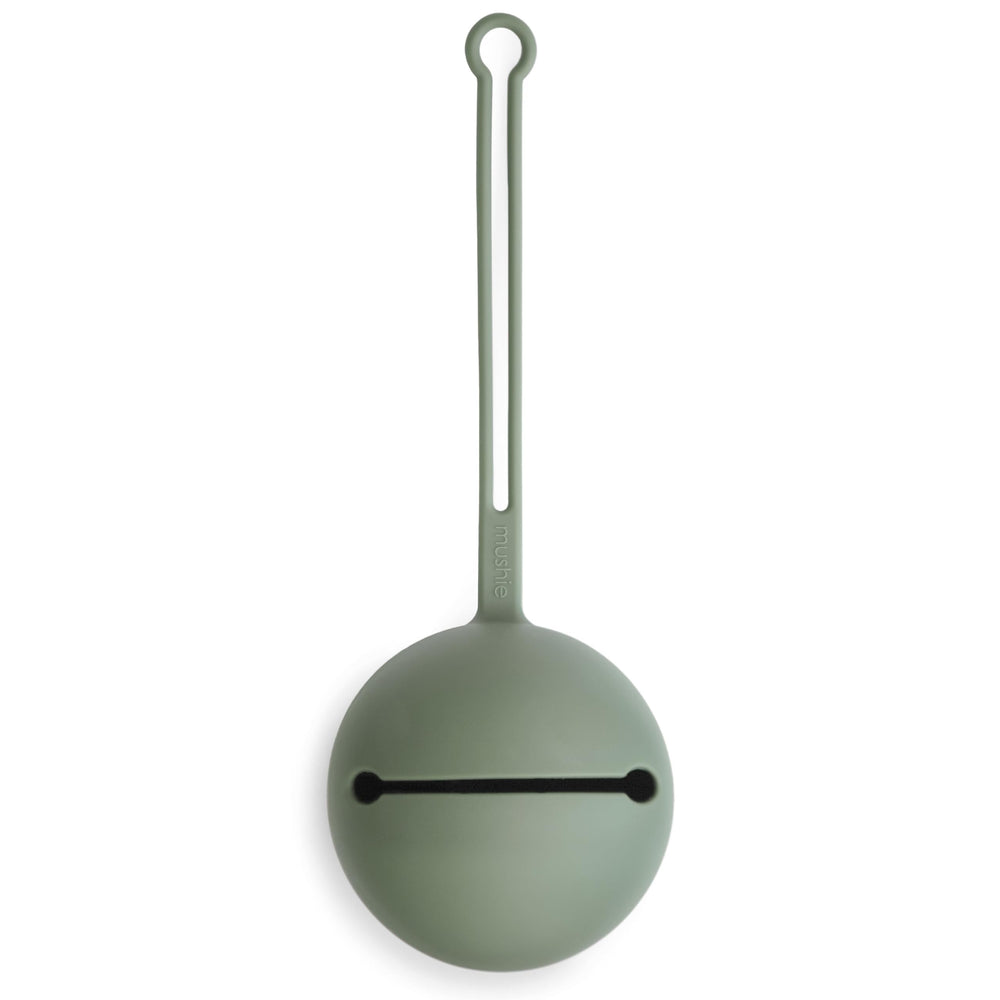 Mushie pacifier holder case in dried thyme close-up showing smooth silicone texture and color