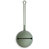 Mushie pacifier holder case in dried thyme close-up showing smooth silicone texture and color