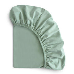 Mushie Stretchy Bassinet Sheet Roman Green on bassinet mattress for secure fit