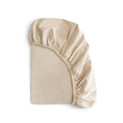 Mushie stretchy mini crib sheet fog folded for easy storage