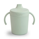 Mushie Trainer Sippy Cup sage with twist lid showing leak-resistant design for on-the-go hydration