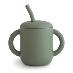 Mushie training cup with lid on, spill-proof design for mess-free meals.
