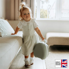 My Carry Potty hanging from pushchair keeps travel-ready potty breaks accessible.