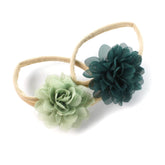 My Lello baby headbands set in light sage and hunter green with soft floral petals.